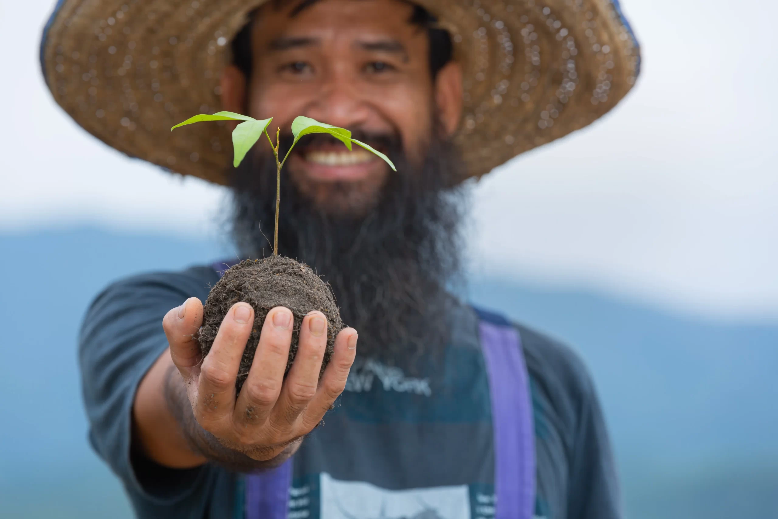 close-up-picture-gardener-s-hand-holding-sapling-plant